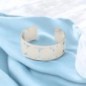 Bracelet manchette de Saint Benoit en acier inoxydable de couleur argenté, ajustable au poignet. Ø intérieur 6.3 cm.