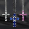 Collier avec chaine et croix H. 3 cm en laiton de couleur argentée. L 40 cm. Existe de différentes couleurs.